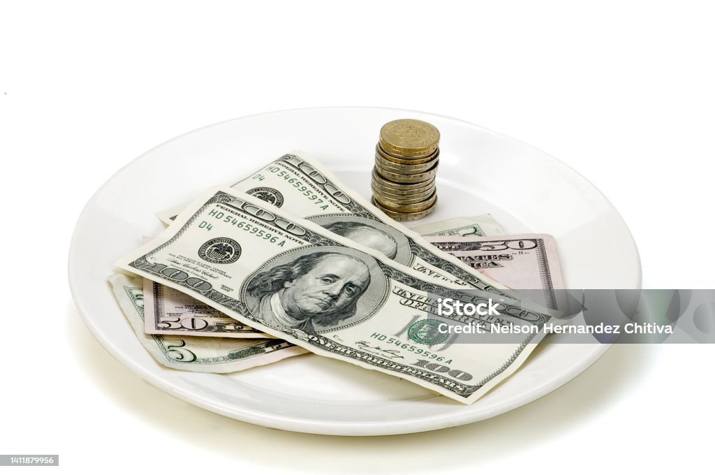 Dollars and coins on a white plate Currency Stock Photo