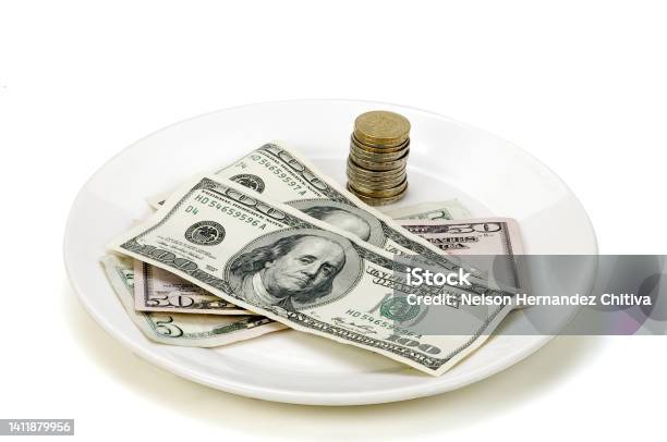 Dollars And Coins On A White Plate Stock Photo - Download Image Now - Currency, Table, Receipt