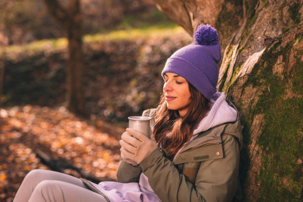 istock Woman drinking hot tea while taking hiking break 1411880040
