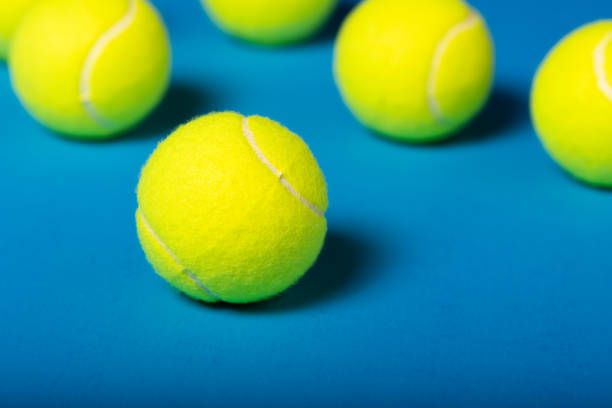 istock Macro shot Yellow Tennis Balls Assorted on Blue Background 1411881184