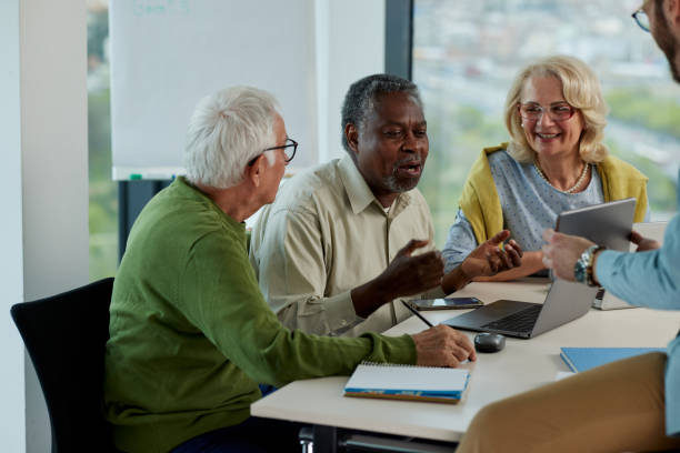istock A group of senior students sit in a classroom with their teacher and work on a school project. 1411881848