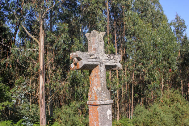 istock a stone cross in the woods 1411883517
