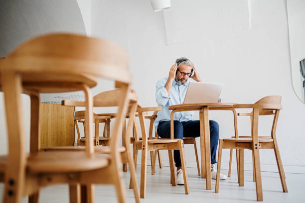istock Mature businessman working at coffee shop 1411886050