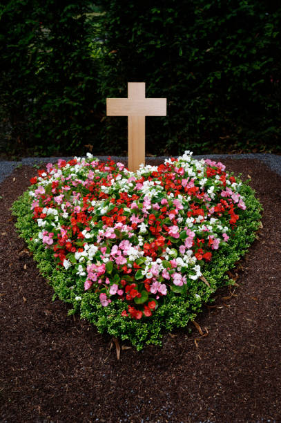 The Rosengarten cemetery is a cemetery in Aarau. It is located in the Zelgliquartier south of the old town. The crematorium located in the middle of the cemetery is listed as a cultural asset of national importance. The image shows several graves captured on a cloudy day during spring season.