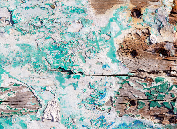 Old wood texture cracked with peeled blue turquoise paint