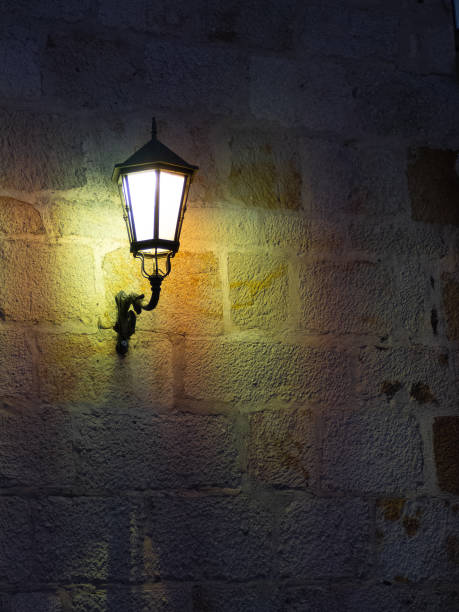 istock aged street lighting lamp in Germany. Image in old color style 1411887413