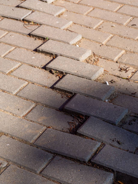 istock Potholes in a sidewalk used by people 1411887424