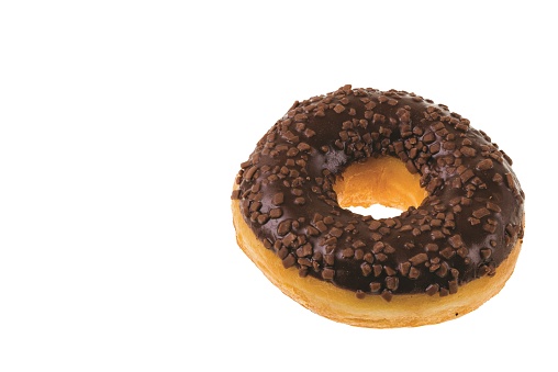 Close up view of chocolate donut sprinkled with nuts isolated on white background.  Sweden.