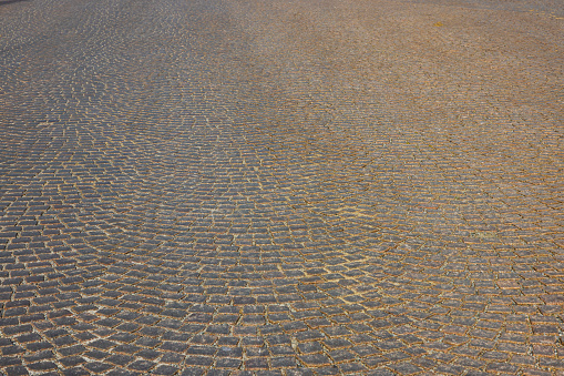 Close up view of texture of paving slabs paved pavement with old cobblestones. Sweden.