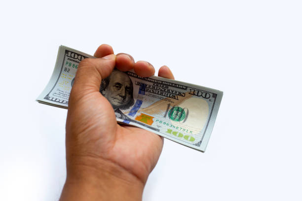 istock Hand with one hundred dollar banknotes. Financial concept 1411891142