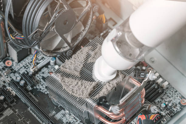 istock Cleaning the radiator in the computer system unit, removing dirt in the computer, overheating the computer 1411891283