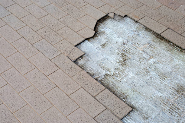 istock Cracked brown tiles on cement floor 1411894337