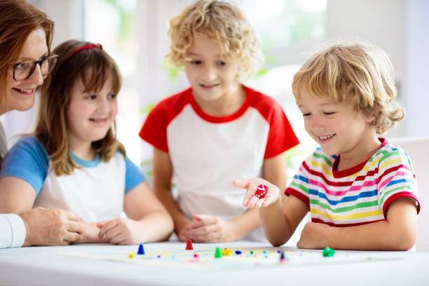 Family playing board game. Kids play. stock photo