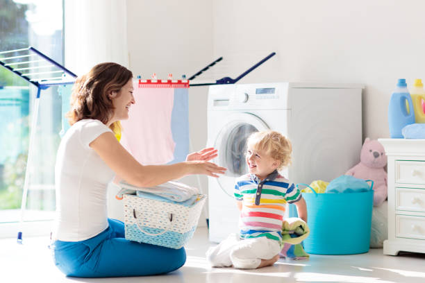istock Family in laundry room with washing machine 1411897189