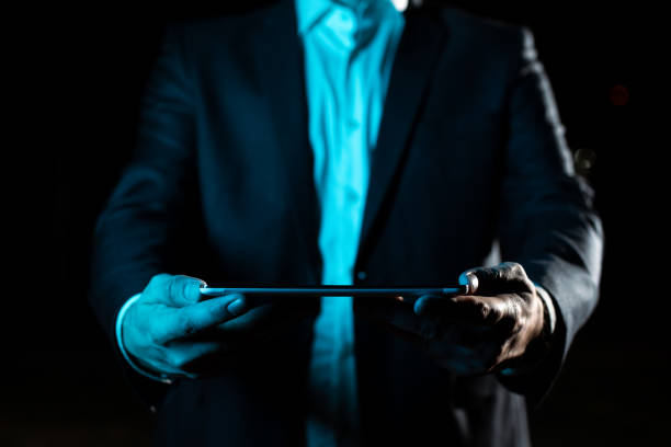 istock Businessman Holding Tablet With Both Hands And Presenting Important Data. Man In Suit Showing Crutial Information. Executive Displaying Crutial Announcement. 1411902014