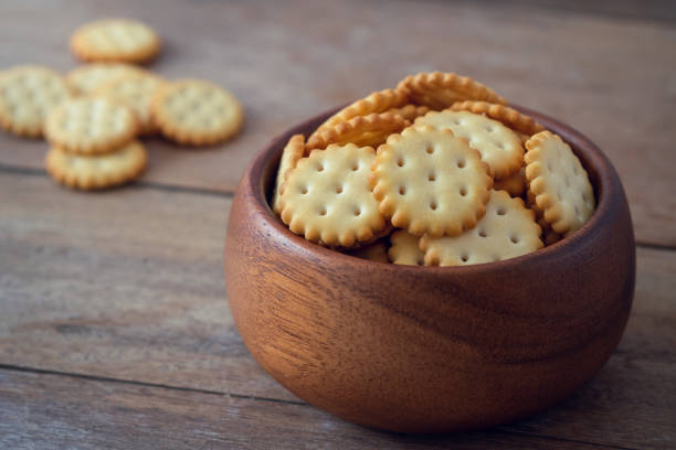 istock Crispy cracker biscuits in wooden bowl 1411902374
