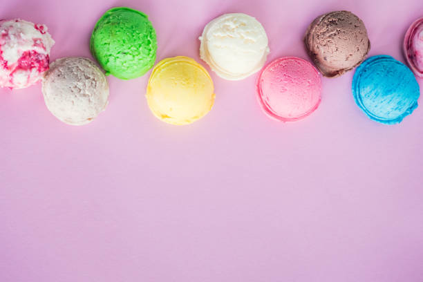 Colorful ice cream scoops on pink background with place for text. Copy space.