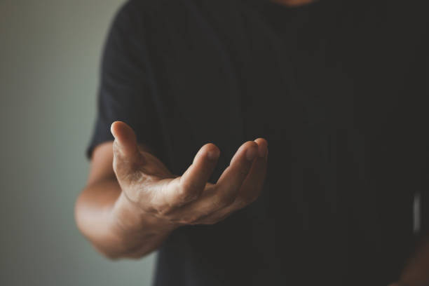 istock Businessman showing empty hand and presenting with hand empty copy space. The man is standing and shows an outstretched hand with an open palm. Open hand, Holding, giving, showing, presenting a concept. 1411906184