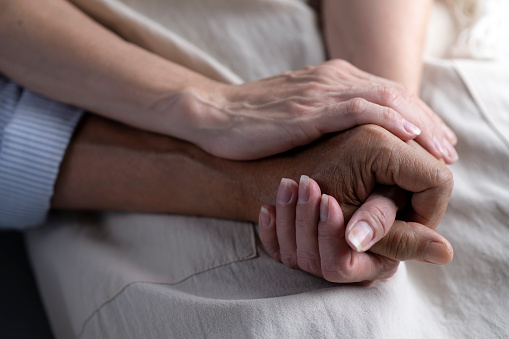 Close up image of senior couple holding hands, loving caring elderly man supporting mature middle aged woman giving psychological empathy and understanding in marriage, getting older together concept