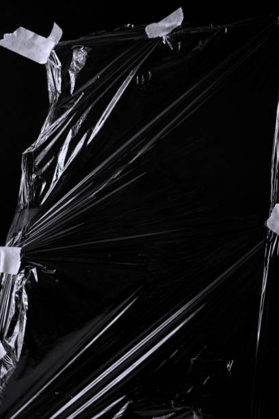 Black transparent plastic wrap texture overlay background. Realistic plastic for poster design and photo overlay effect. Wrinkled plastic surface pattern for graphic design sources and element.