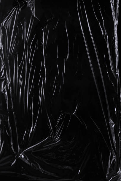istock Black transparent plastic wrap texture overlay background. Realistic plastic for poster design and photo overlay effect. Wrinkled plastic surface pattern for graphic design sources and element. 1411916291