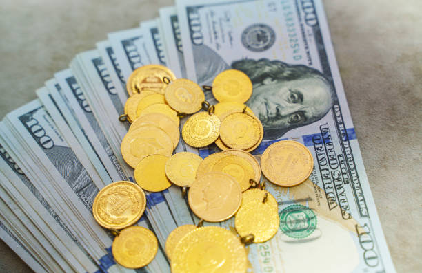 große gruppe von goldmünzen mit us-dollar-banknoten - gold jewelry currency buying stock-fotos und bilder