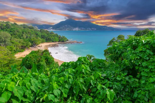 Photo of Colourful Skies Sunset over Head Laem Sing Beach in Phuket Thailand. This Lovely island waters are turquoise blue waters, lush green mountains colourful skies and beautiful views of Pa Tong Patong