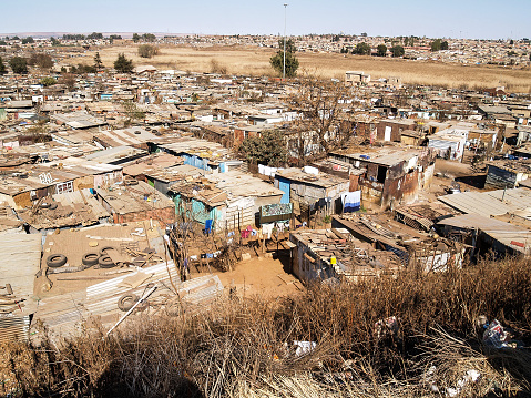 Rusting corrugated iron structures crammed into slum village in Soweto, Johannesburg South Africa.