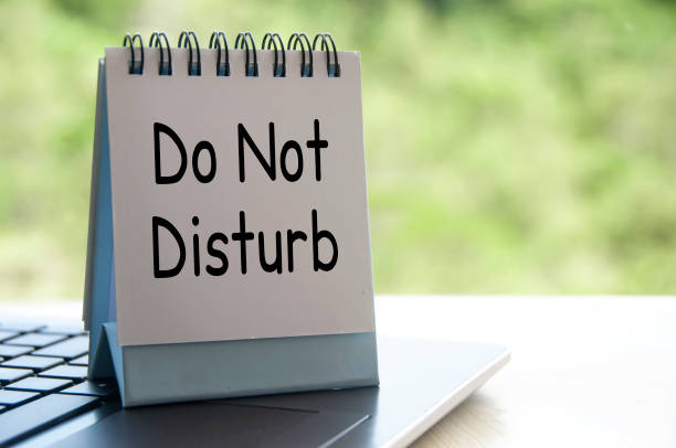 istock Do not disturb text on white table calendar on laptop keyboard. Do not disturb concept 1411928168