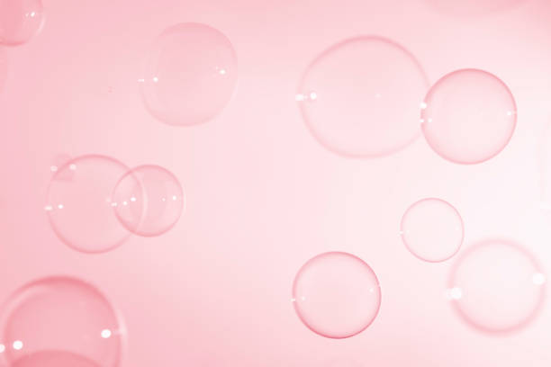 istock Abstract Beautiful Transparent Pink Soap Bubbles Background. Soap Sud Bubbles Water. 1411929119