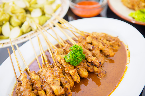 Close up of tasty chicken satay and other foods served at Eid Mubarak celebration