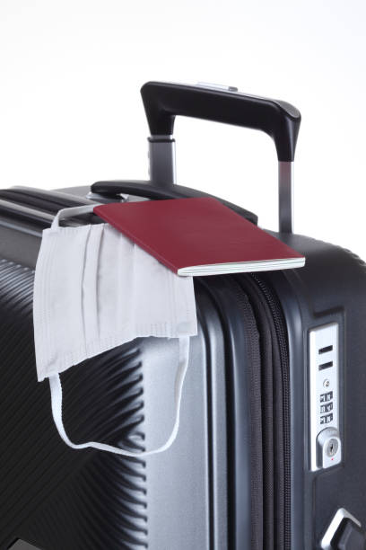 istock suitcase, passport and medical mask 1411929813