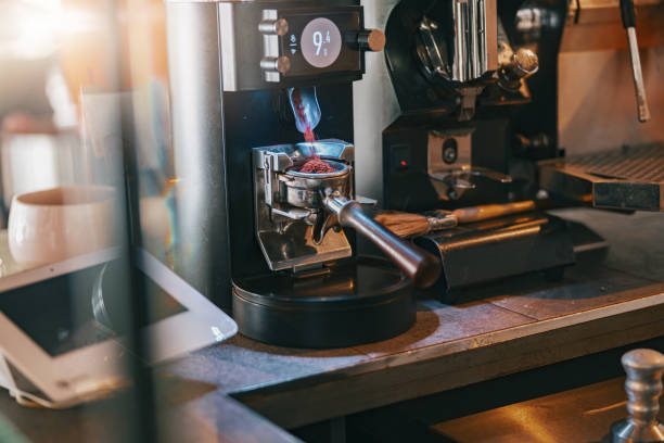 istock Process of grinding coffee beans pouring into a portafilter using coffee machine 1411933054