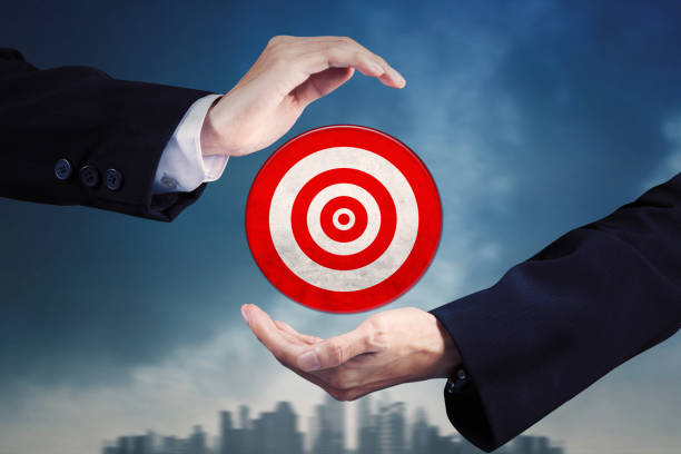 istock Businessman hands showing a red dartboard 1411933060
