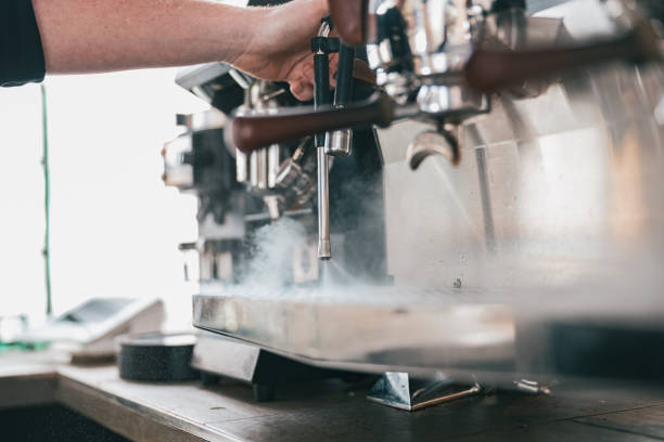 istock Coffee machine in steam, barista preparing coffee at cafe 1411933203