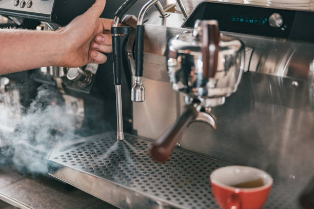 istock Coffee machine in steam, barista preparing coffee at cafe 1411933251