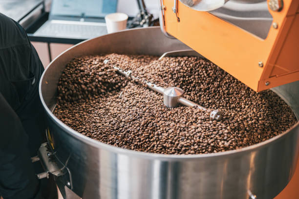 primer plano de la máquina de tostado de café con granos de café en la fabricación de café pequeño - roasted machine bean mixing fotografías e imágenes de stock