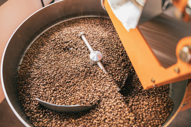 primer plano de la máquina de tostado de café con granos de café en la fabricación de café pequeño - roasted machine bean mixing fotografías e imágenes de stock