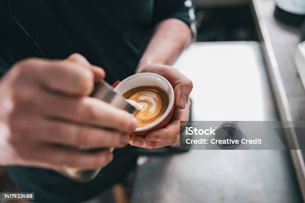 Professional Barista Pouring Milk In Cup Of Fresh Made Coffee For Making Latte Or Cappuccino Stock Photo - Download Image Now
