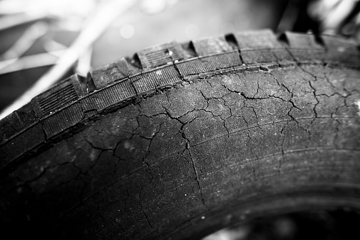 close up of an old and cracked car tire passing old worn out time