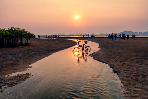 A meandering river appears on Ha Pak Nai Beach at low tide. Many people come here to enjoy the sunset and play.