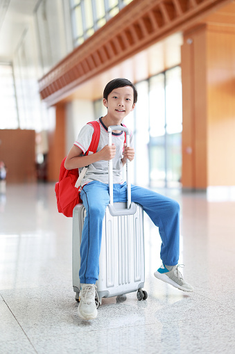 Little boy waiting in the airport, child travel