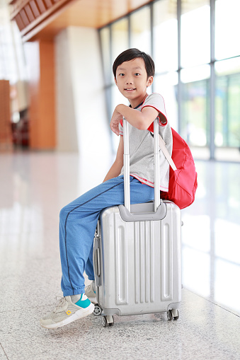 Little boy waiting in the airport, child travel