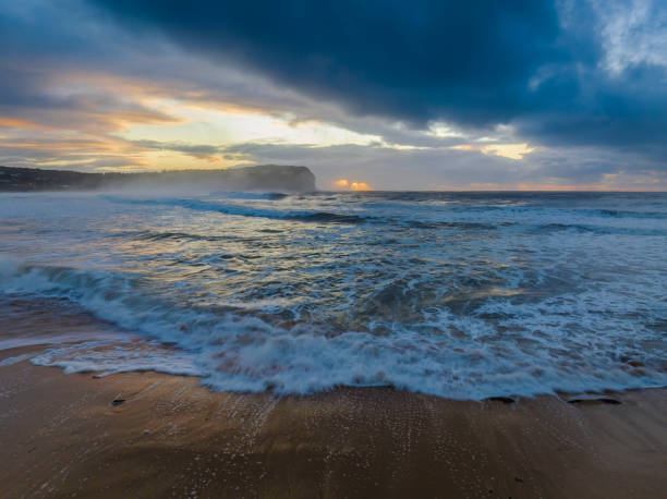 istock Sunrise at the seaside with large and powerful sets 1411937214