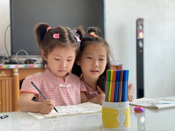 istock Two Asian children are drawing 1411937723