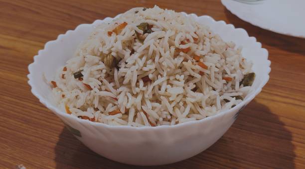istock Veg fried rice with carrot and beams in White bowl. 1411938399
