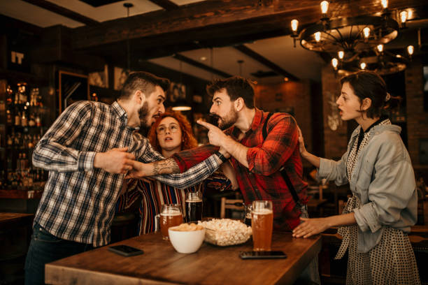 Boys fighting in a pub A two young adult bearded guys having an argument, getting a bit physical while in the pub with their girlfriends, that are trying to separate them. Both are wearing a plaid shirts, treating each other clash of clans stock pictures, royalty-free photos & images