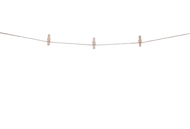 istock Blank wood clothes pins three patterns hanging on brown rope isolated on white background , clipping path 1411941713
