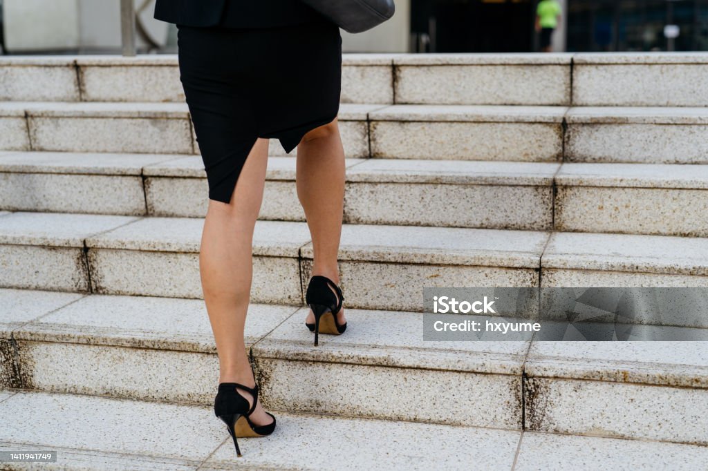 Busnesswoman walking upstairs Business Stock Photo