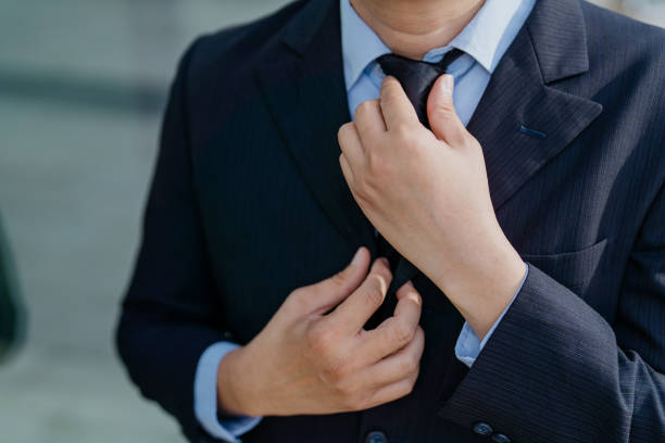 A man in a black suit with a black tie
